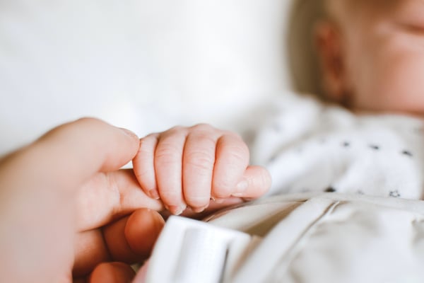 person-holding-baby-s-hand-2721581